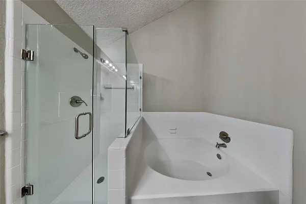 a bathroom with a tub and shower