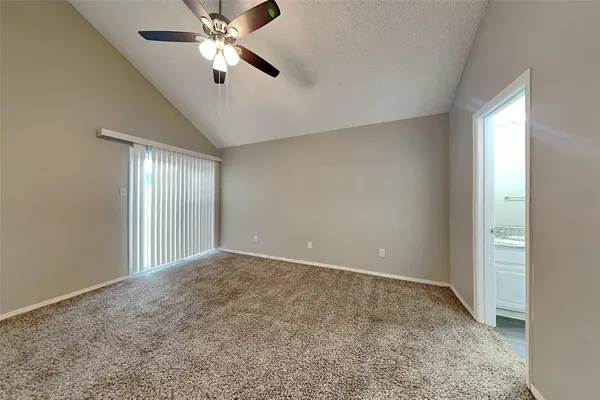 a view of an empty room and window chandelier fan
