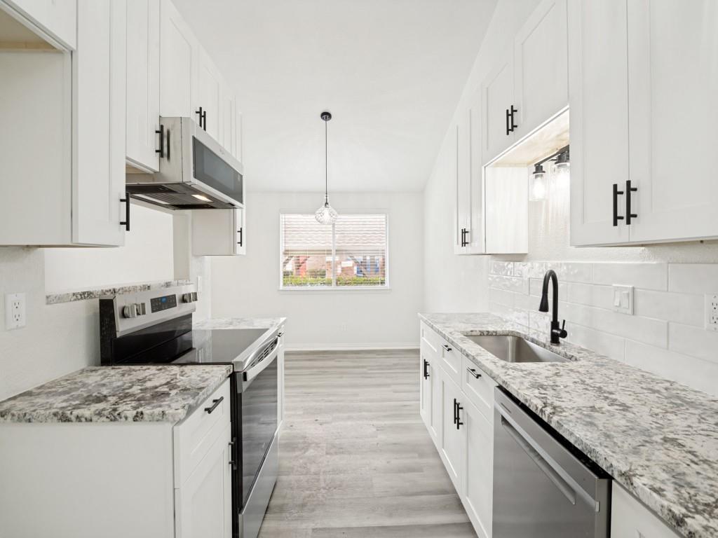 2240 Tarpley Road, Unit 92 Carrollton, TX 75006 - Photo 7 of 22 a kitchen with stainless steel appliances granite countertop a sink stove and cabinets
