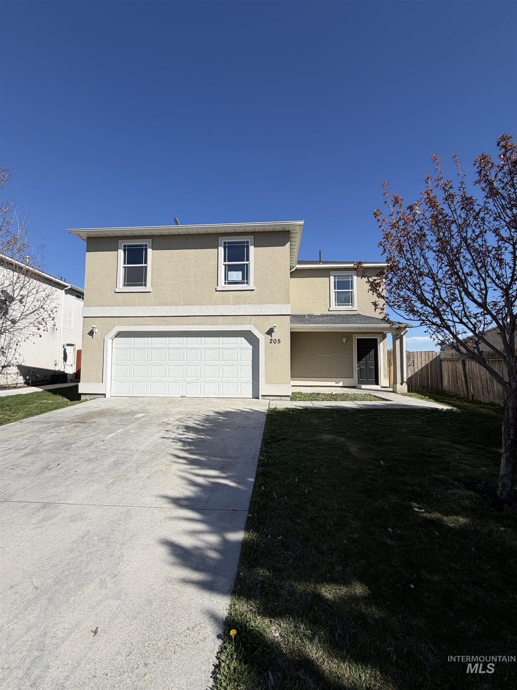 205 Middlepark Way Caldwell, ID 83605 - Photo 1 of 18 Traditional home with a garage, stucco siding, driveway, and a porch