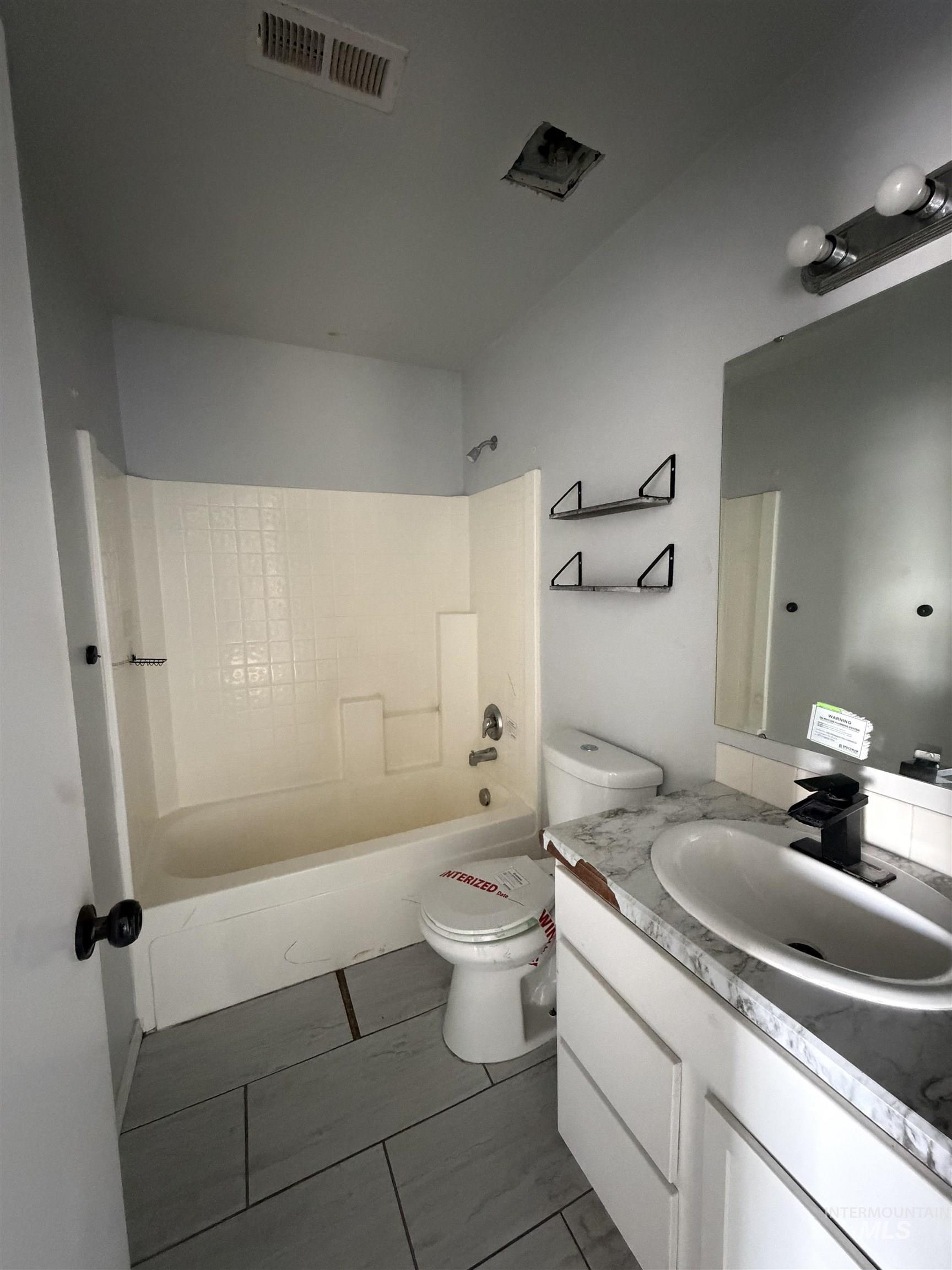 205 Middlepark Way Caldwell, ID 83605 - Photo 12 of 18 Full bathroom featuring vanity and bathtub / shower combination