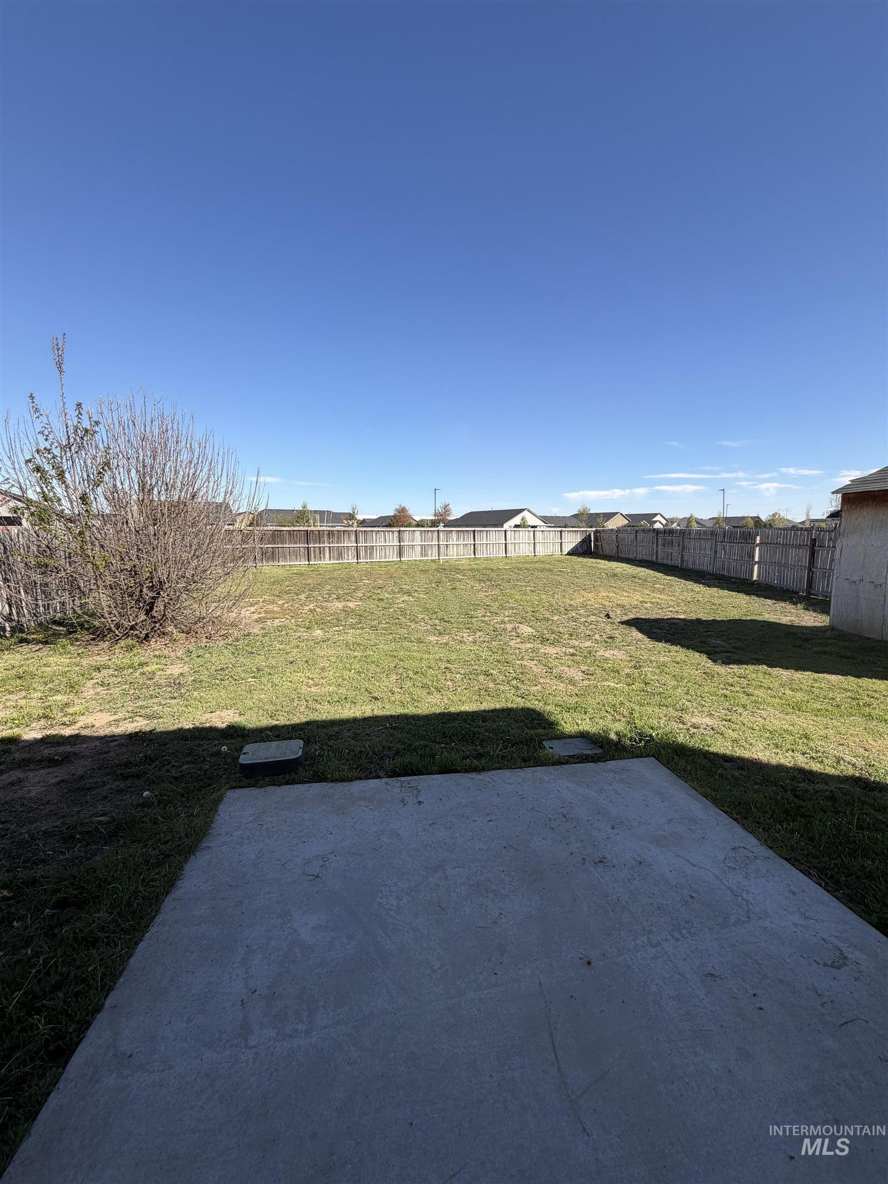205 Middlepark Way Caldwell, ID 83605 - Photo 18 of 18 Fenced backyard with a patio