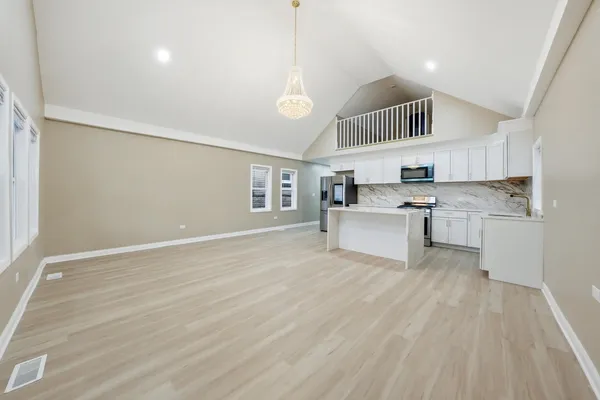 a view of kitchen with cabinets and wooden floor