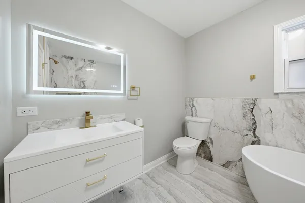 a bathroom with a toilet a sink and a bathtub