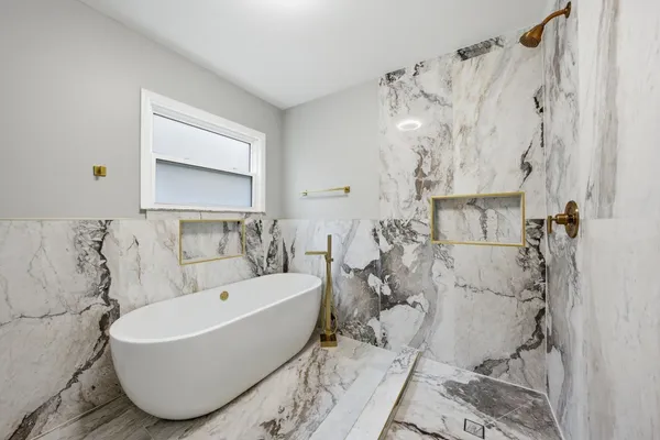 a bathroom with a bathtub and shower