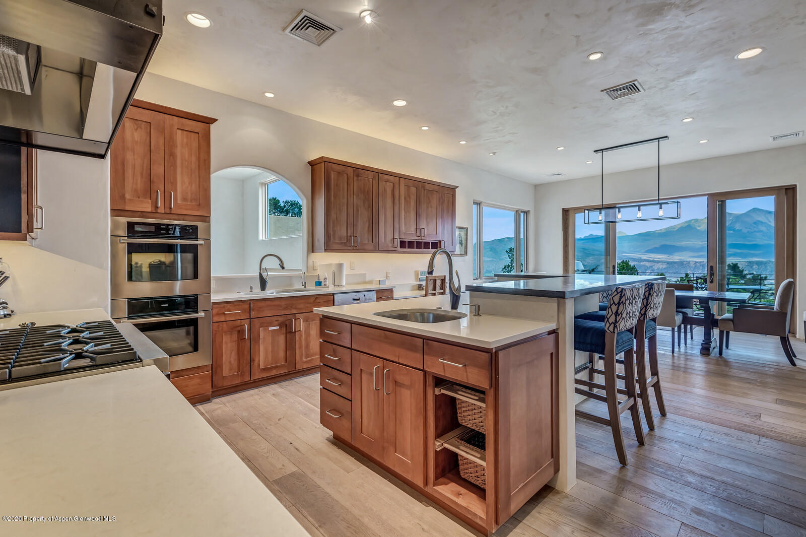 475 County Road 112 Carbondale, CO 81623 - Photo 13 of 53 a kitchen with kitchen island granite countertop a stove top oven a sink a dining table and chairs with wooden floor