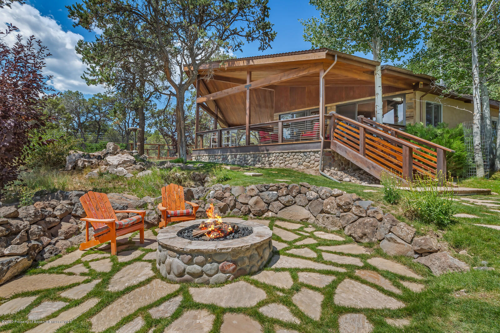475 County Road 112 Carbondale, CO 81623 - Photo 30 of 53 a view of a backyard with table and chairs under an umbrella