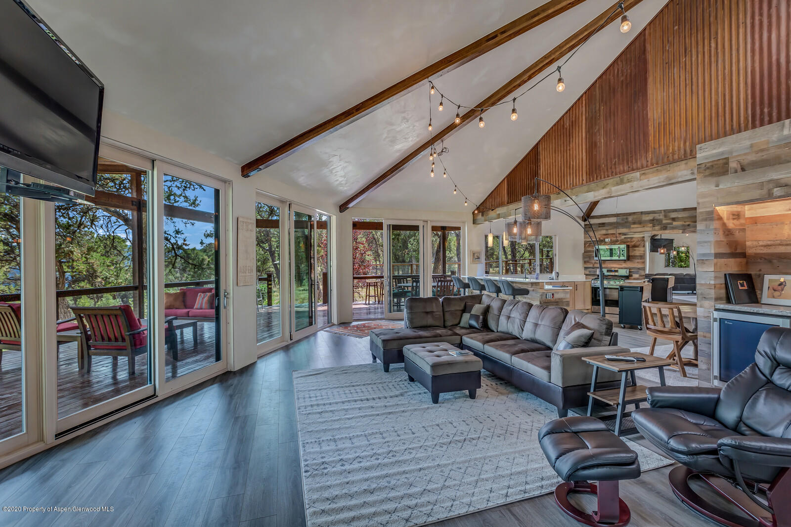 475 County Road 112 Carbondale, CO 81623 - Photo 32 of 53 a living room with furniture a flat screen tv and floor to ceiling window