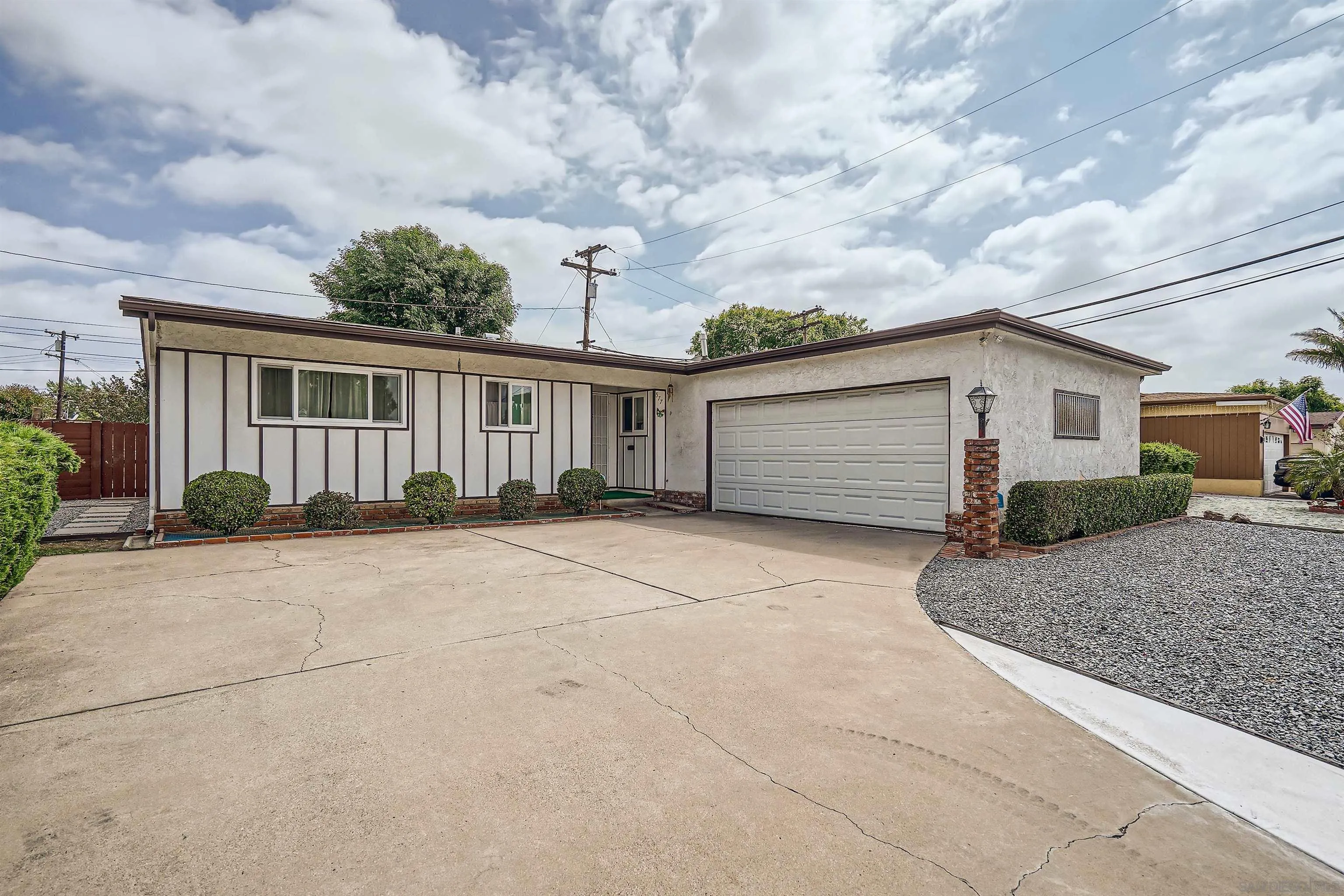 a view of a house with a backyard and garage