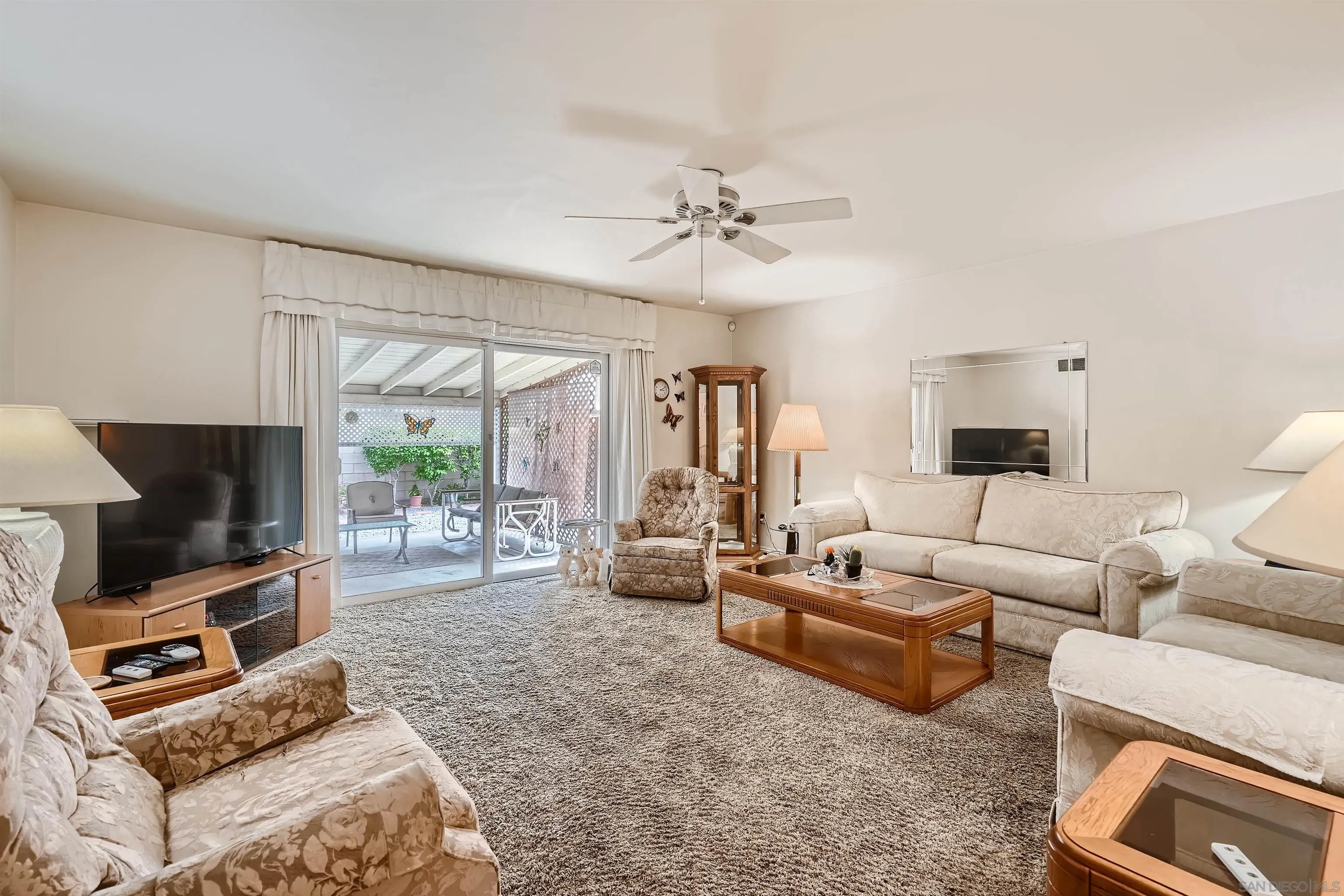 577 Cedar Street El Cajon, CA 92021 - Photo 2 of 11 a living room with furniture a flat screen tv and a large window