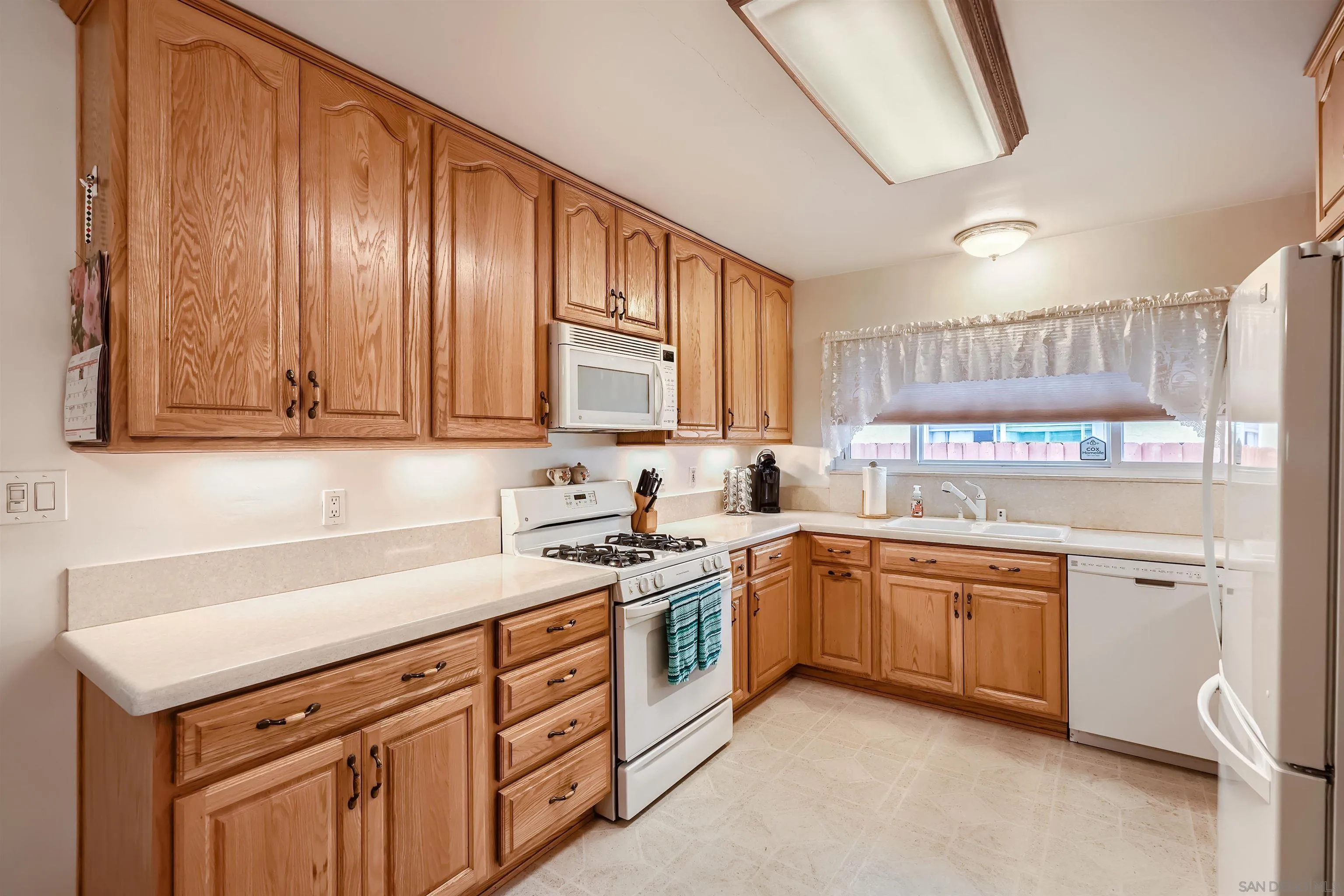577 Cedar Street El Cajon, CA 92021 - Photo 4 of 11 a kitchen with stainless steel appliances granite countertop a sink and cabinets
