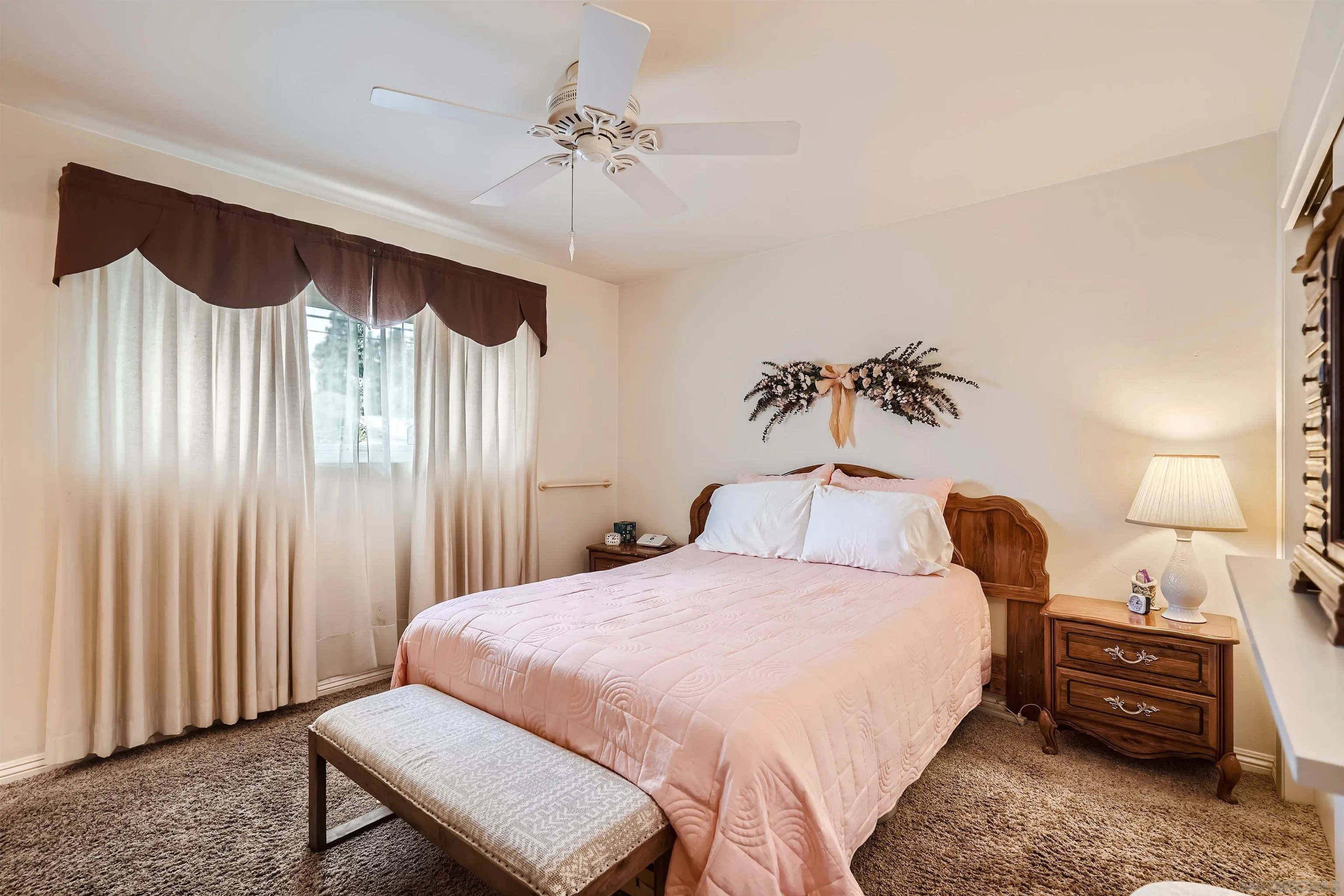 577 Cedar Street El Cajon, CA 92021 - Photo 5 of 11 a bedroom with a bed and a chandelier