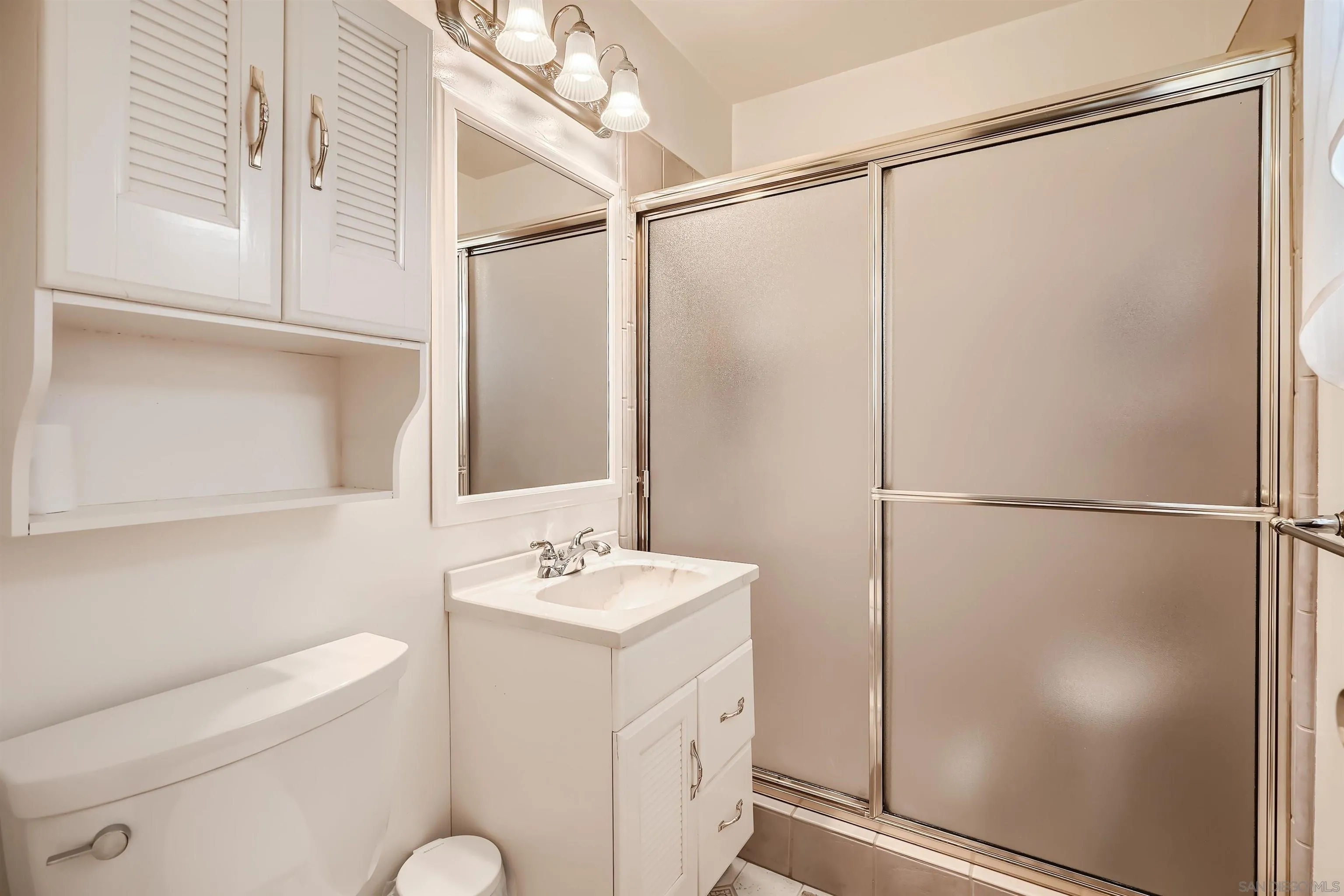 577 Cedar Street El Cajon, CA 92021 - Photo 6 of 11 a bathroom with a sink a mirror and a shower