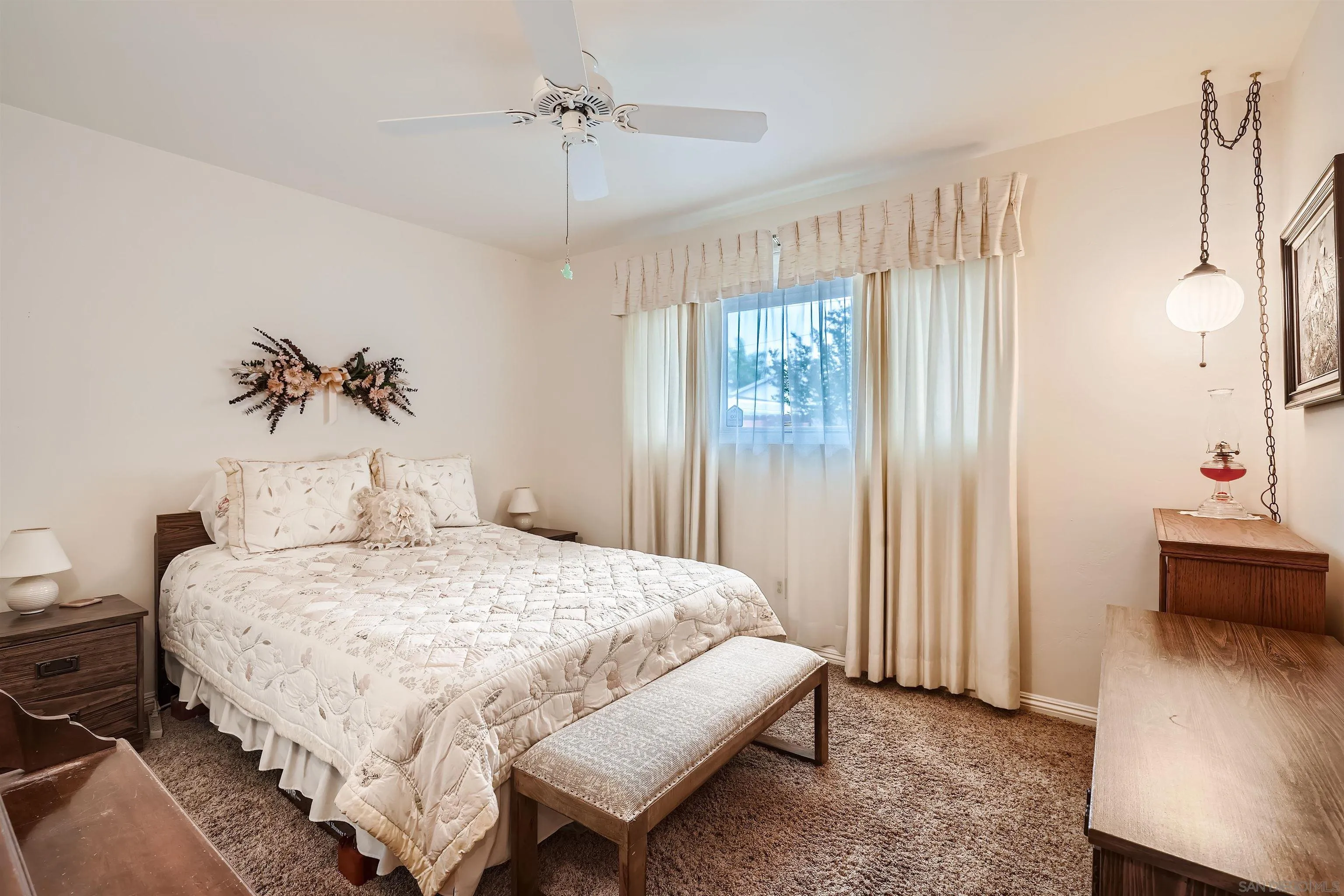 577 Cedar Street El Cajon, CA 92021 - Photo 7 of 11 a bedroom with a large bed and a chandelier