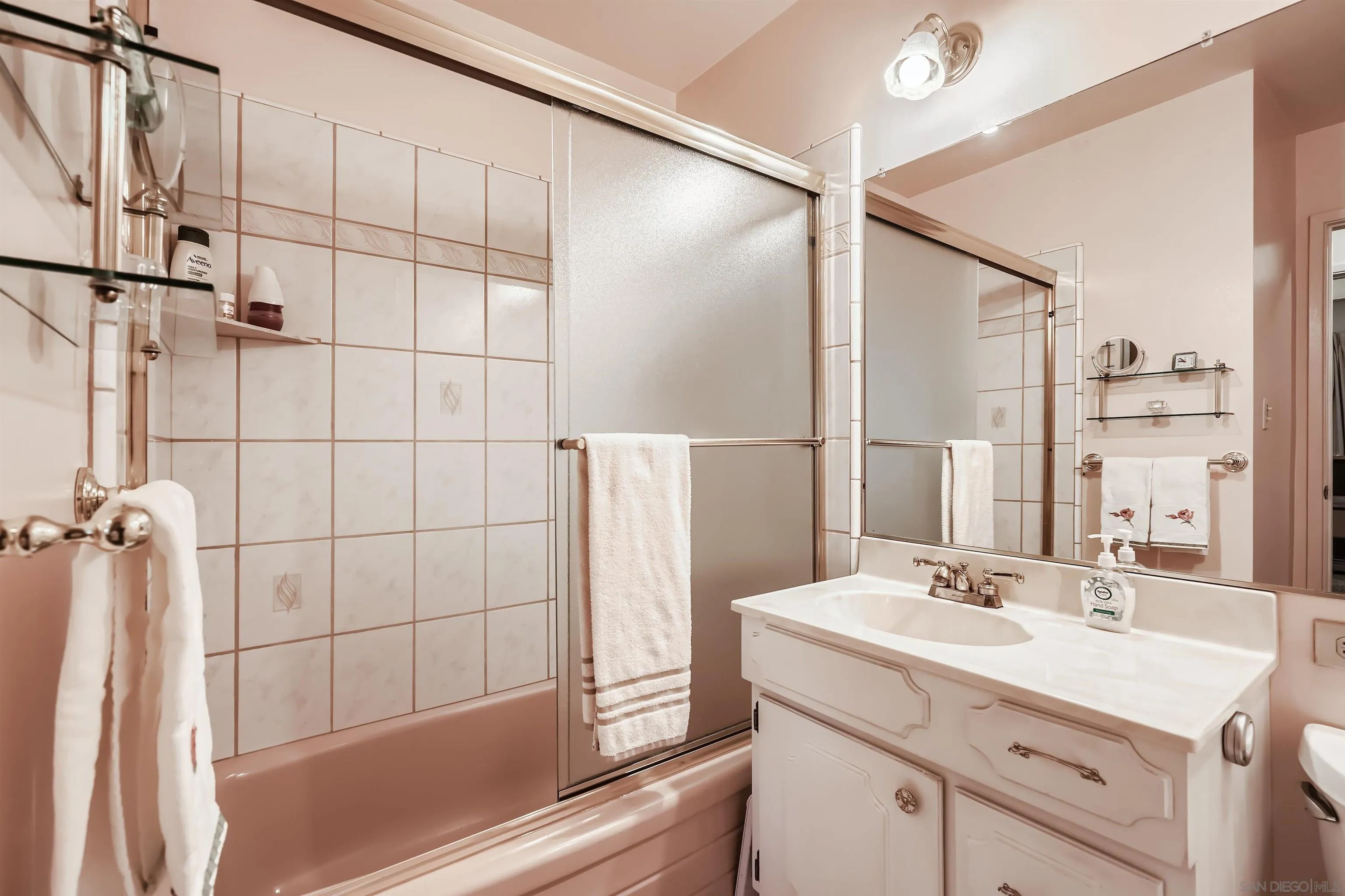 577 Cedar Street El Cajon, CA 92021 - Photo 8 of 11 a bathroom with a shower sink and mirror