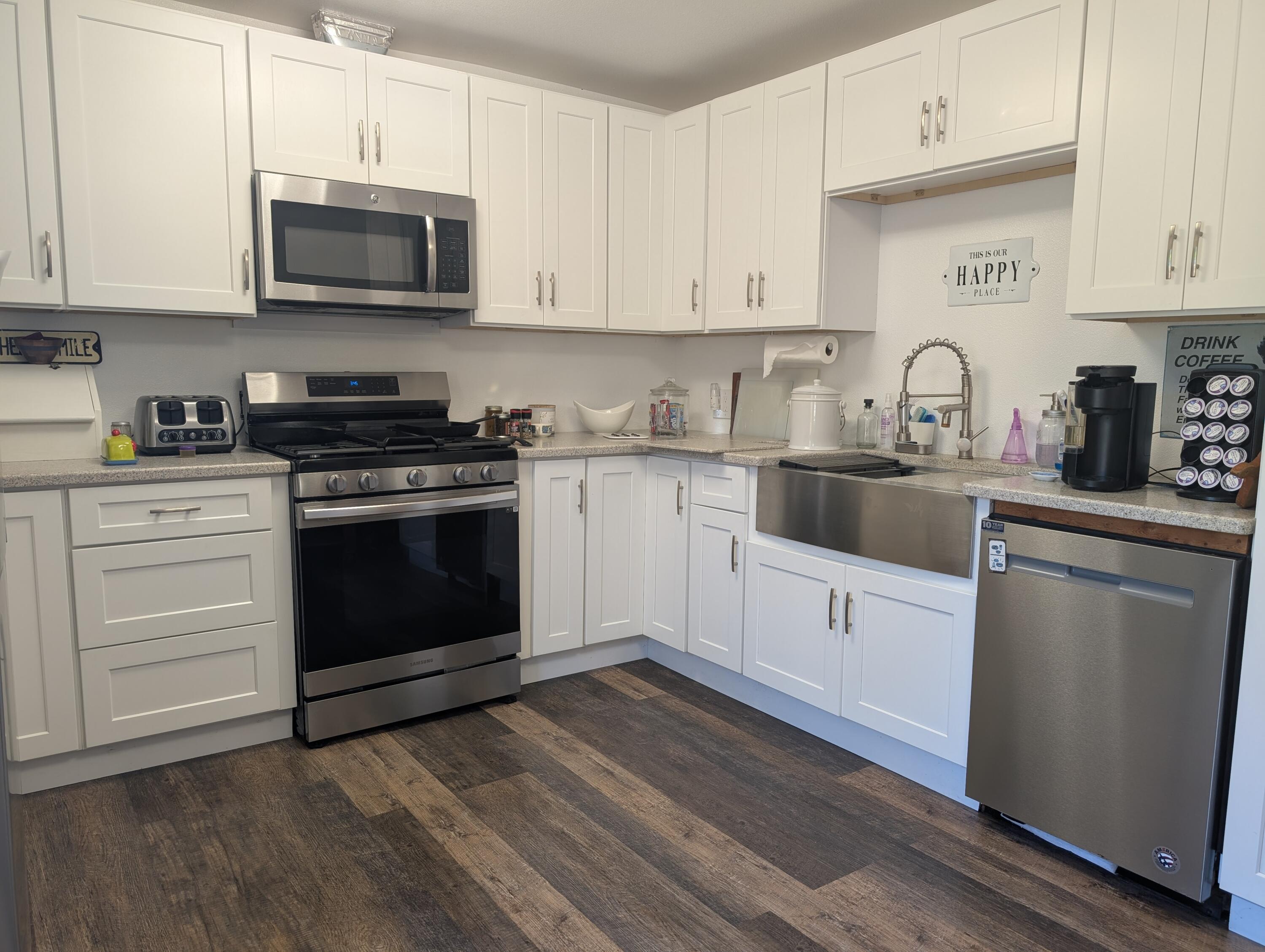 698 Wilson Road Central Point, OR 97502 - Photo 3 of 7 a kitchen with granite countertop white cabinets and stainless steel appliances