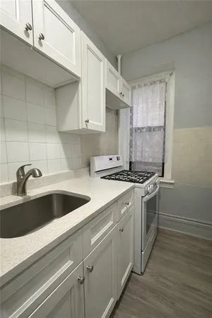 a kitchen with a sink cabinets and stainless steel appliances