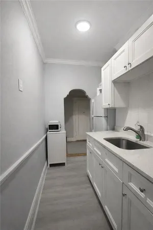 a kitchen with sink and cabinets