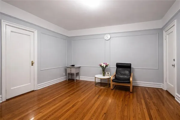 a room with wooden floor and furniture