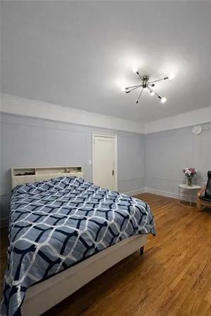 a bedroom with a bed and a lamp