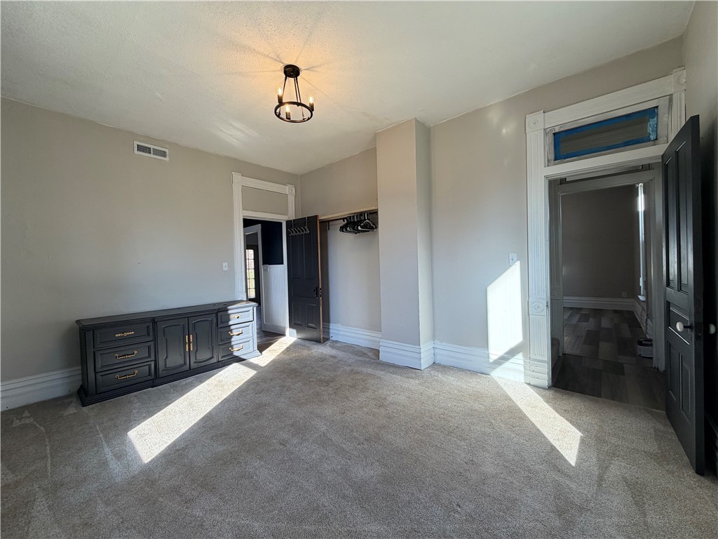 230 West Decatur Street Eaton, OH 45320 - Photo 17 of 22 This spacious room offers comfort with carpeted floors and classic architectural trim.