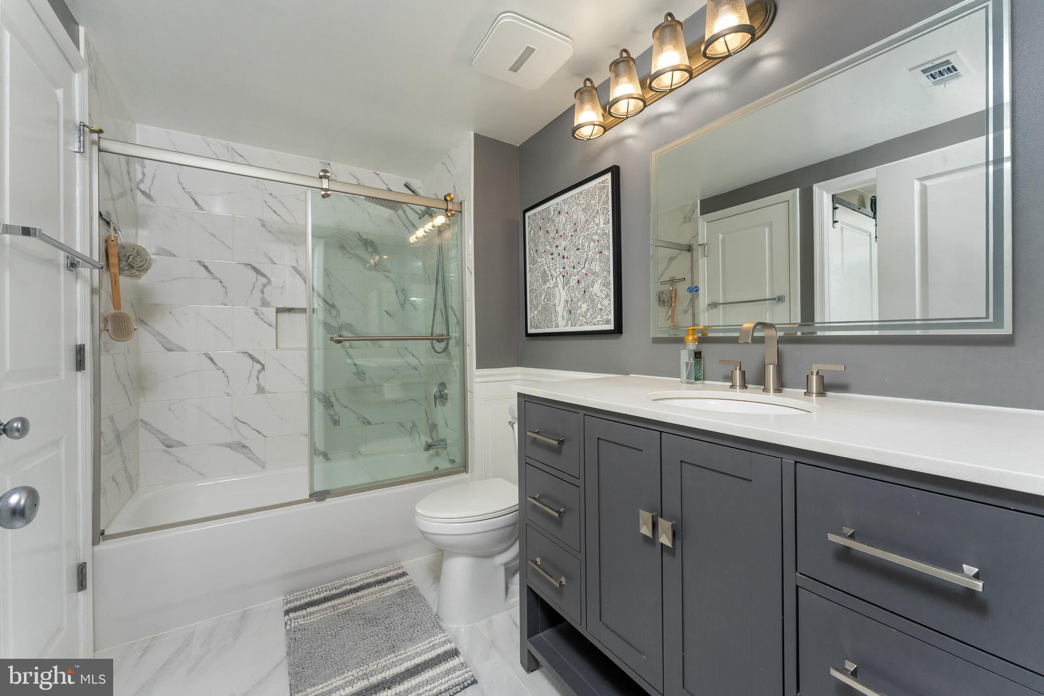 851 North Glebe Road, Unit 1818 Arlington, VA 22203 - Photo 12 of 23 a bathroom with a double vanity sink mirror and toilet