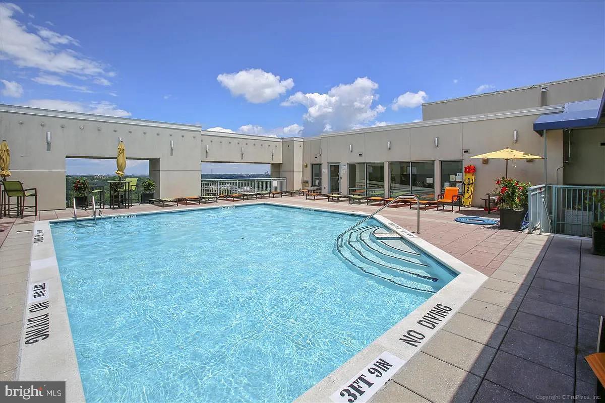 851 North Glebe Road, Unit 1818 Arlington, VA 22203 - Photo 22 of 23 a swimming pool with outdoor seating and yard