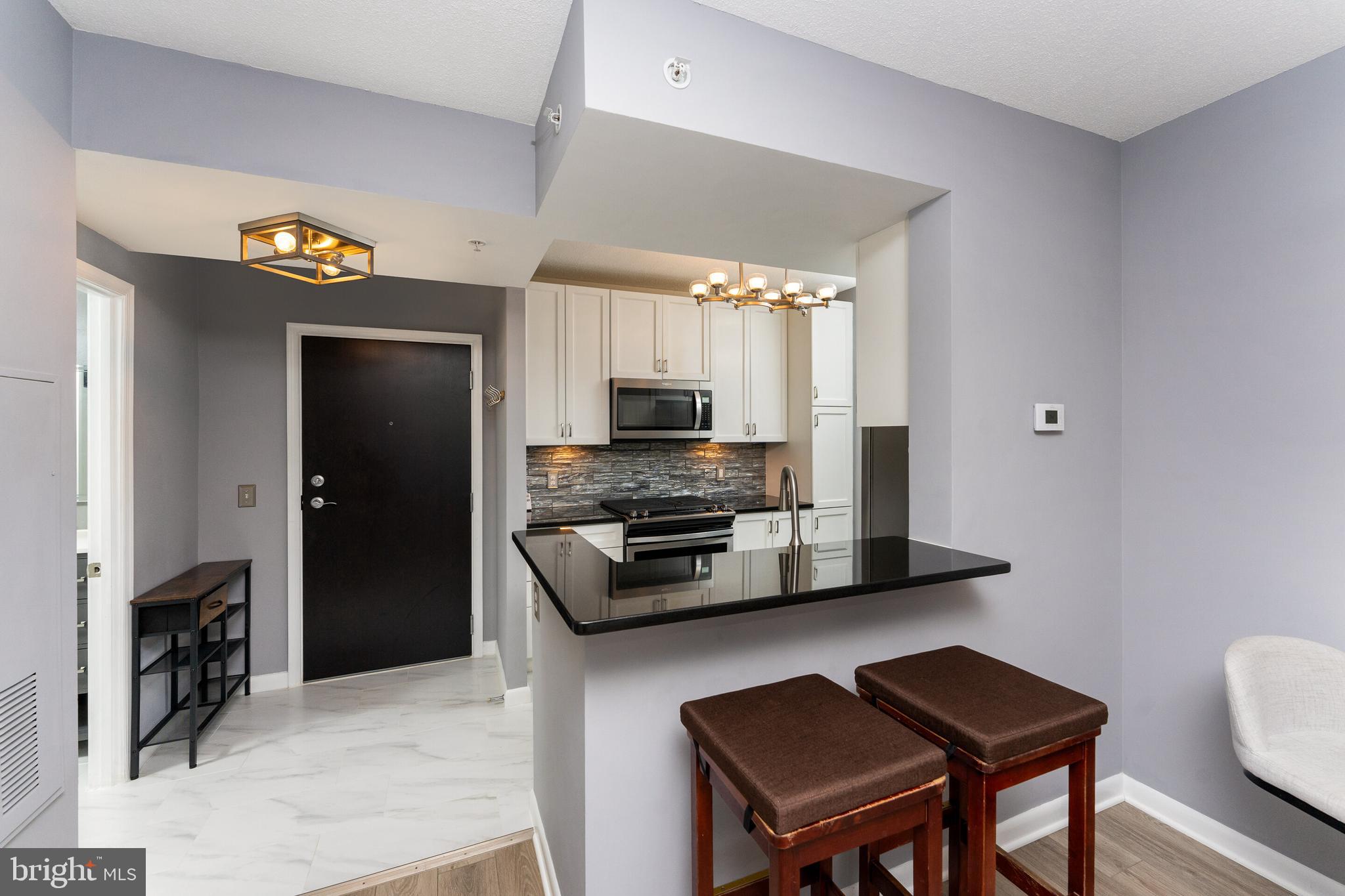 851 North Glebe Road, Unit 1818 Arlington, VA 22203 - Photo 6 of 23 a kitchen with a refrigerator and a stove top oven