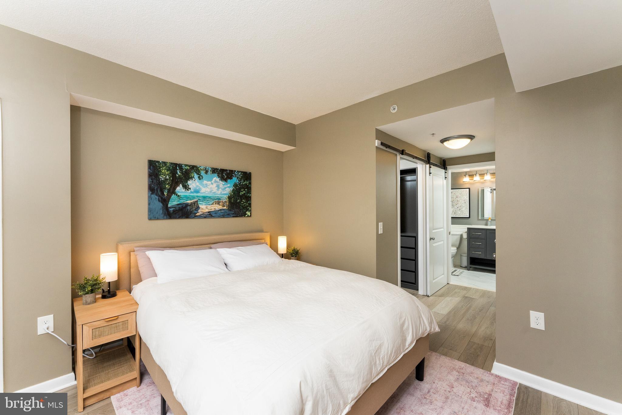 851 North Glebe Road, Unit 1818 Arlington, VA 22203 - Photo 9 of 23 a bedroom with a large bed and a chandelier