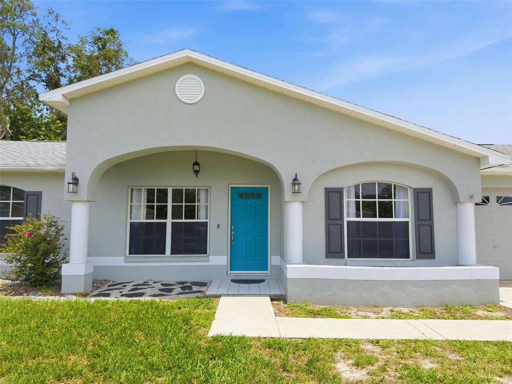 2202 Godfrey Avenue Spring Hill, FL 34609 - Photo 6 of 36 a front view of a house with a yard