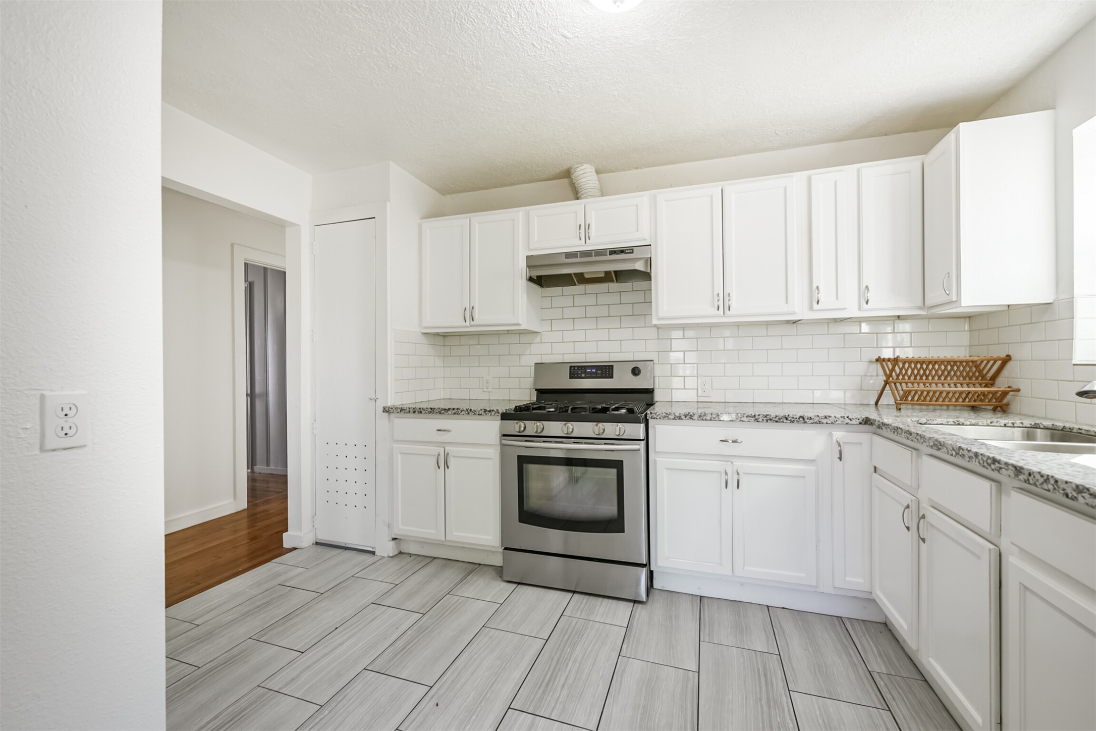 7546 Greendowns Street Houston, TX 77087 - Photo 13 of 33 a kitchen with stainless steel appliances granite countertop a stove a sink and a refrigerator