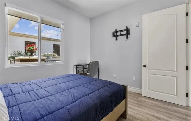 a bedroom with a bed and wooden floor