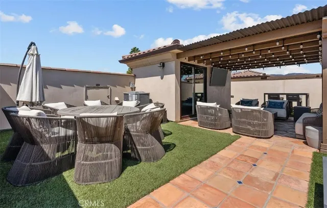 a view of a patio with table and chairs