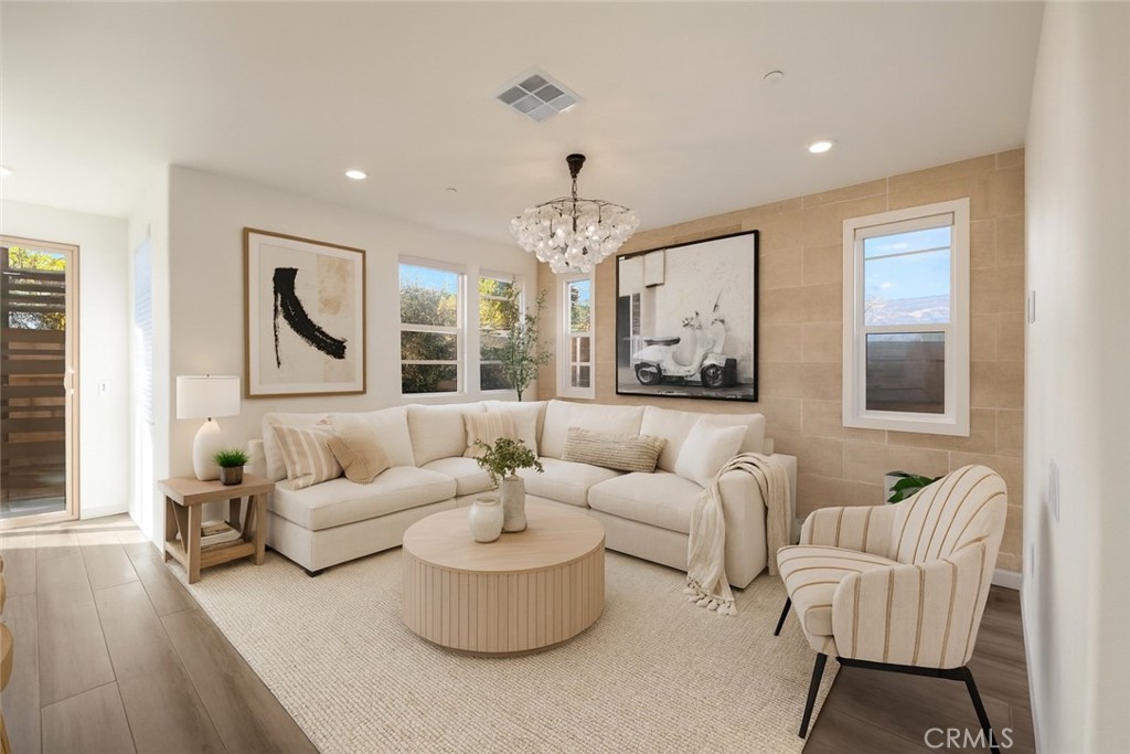 a living room with furniture and a chandelier