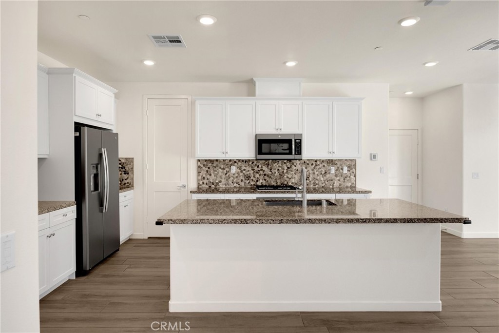 2323 Apple Upland, CA 91786 - Photo 11 of 57 a large kitchen with stainless steel appliances granite countertop a refrigerator a stove and a sink