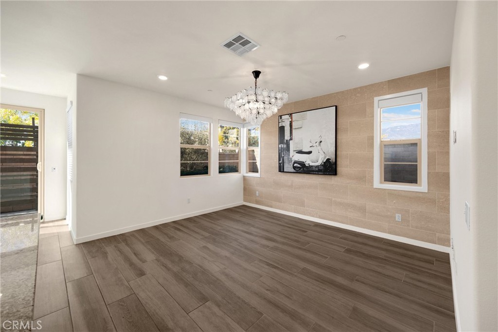 2323 Apple Upland, CA 91786 - Photo 13 of 57 an empty room with wooden floor chandelier and windows