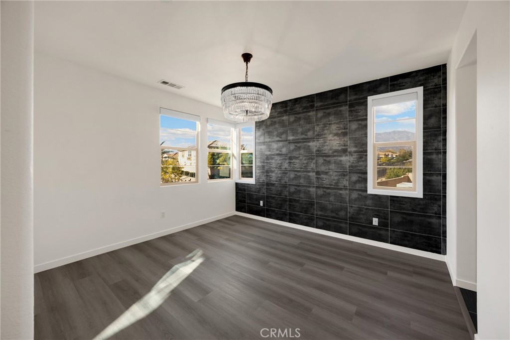 2323 Apple Upland, CA 91786 - Photo 24 of 57 a view of an empty room with wooden floor and a window
