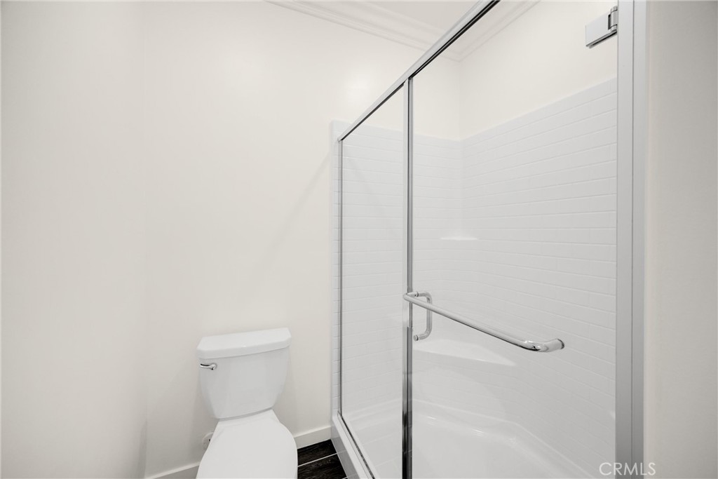 2323 Apple Upland, CA 91786 - Photo 27 of 57 a white toilet sitting next to a shower