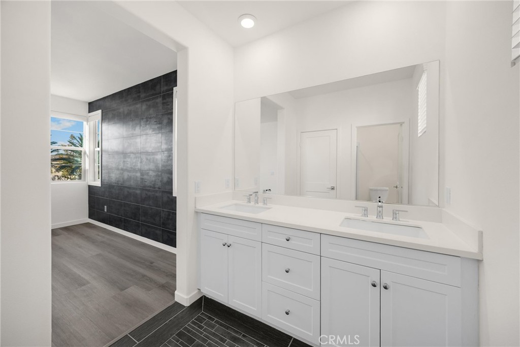 2323 Apple Upland, CA 91786 - Photo 28 of 57 a bathroom with a double vanity sink and mirror