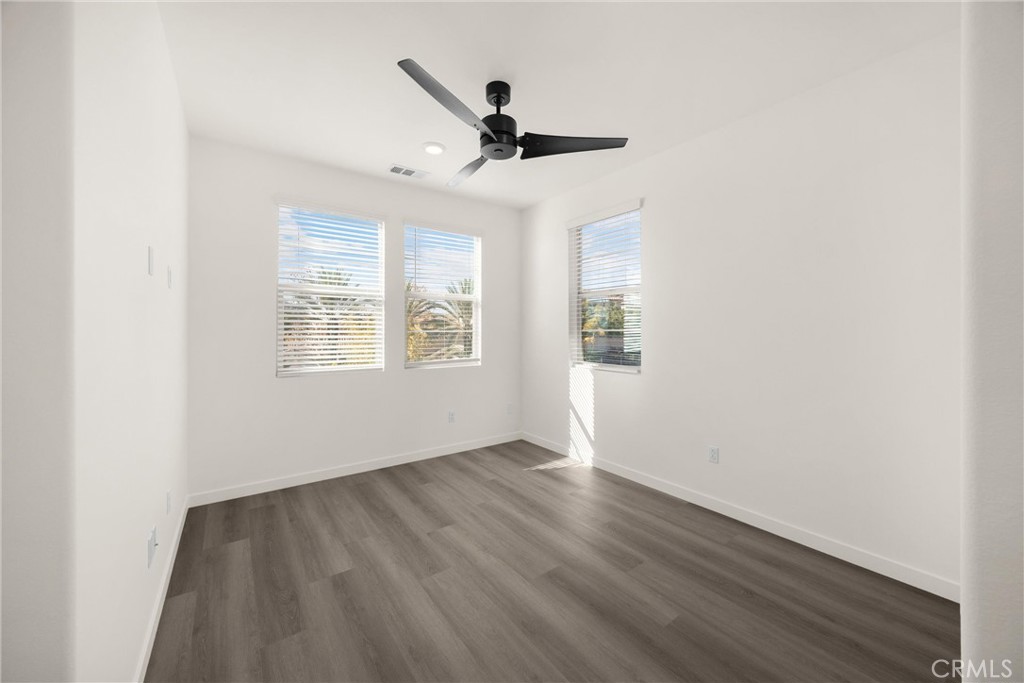 2323 Apple Upland, CA 91786 - Photo 29 of 57 an empty room with wooden floor chandelier fan and windows