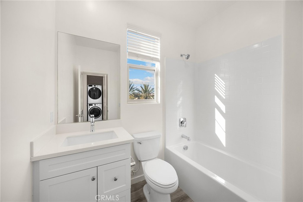 2323 Apple Upland, CA 91786 - Photo 31 of 57 a bathroom with a toilet sink a mirror and next to a window