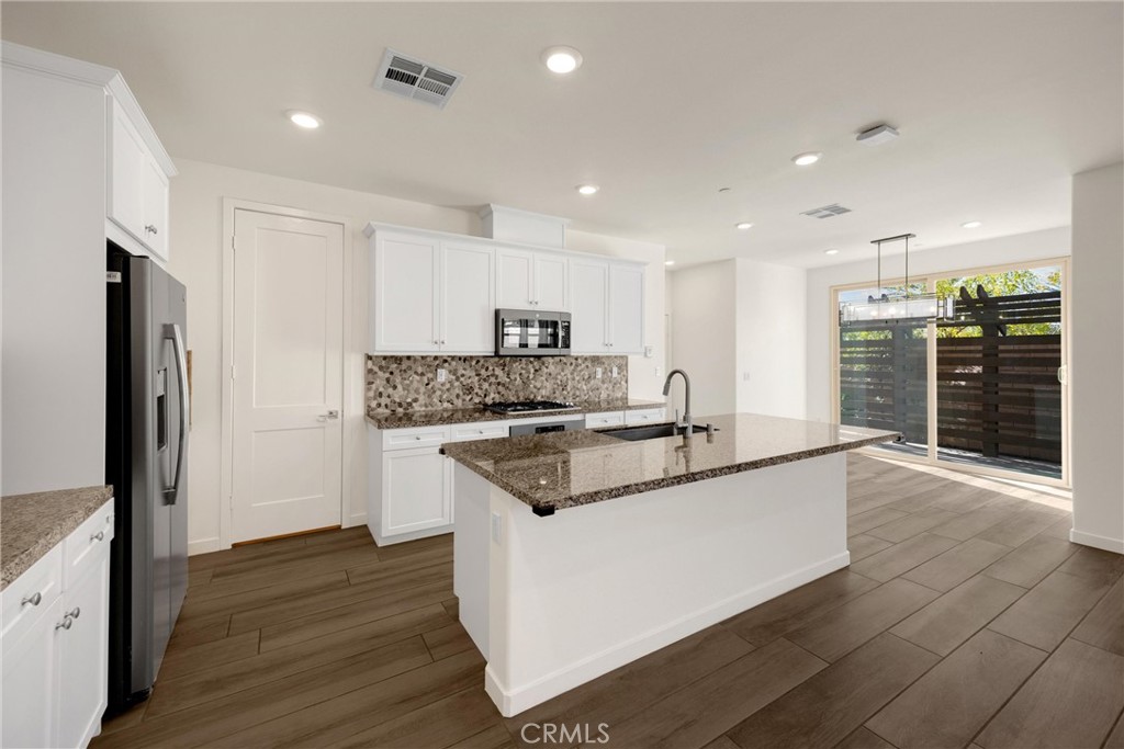 2323 Apple Upland, CA 91786 - Photo 5 of 57 a kitchen with stainless steel appliances granite countertop a sink and a stove top oven