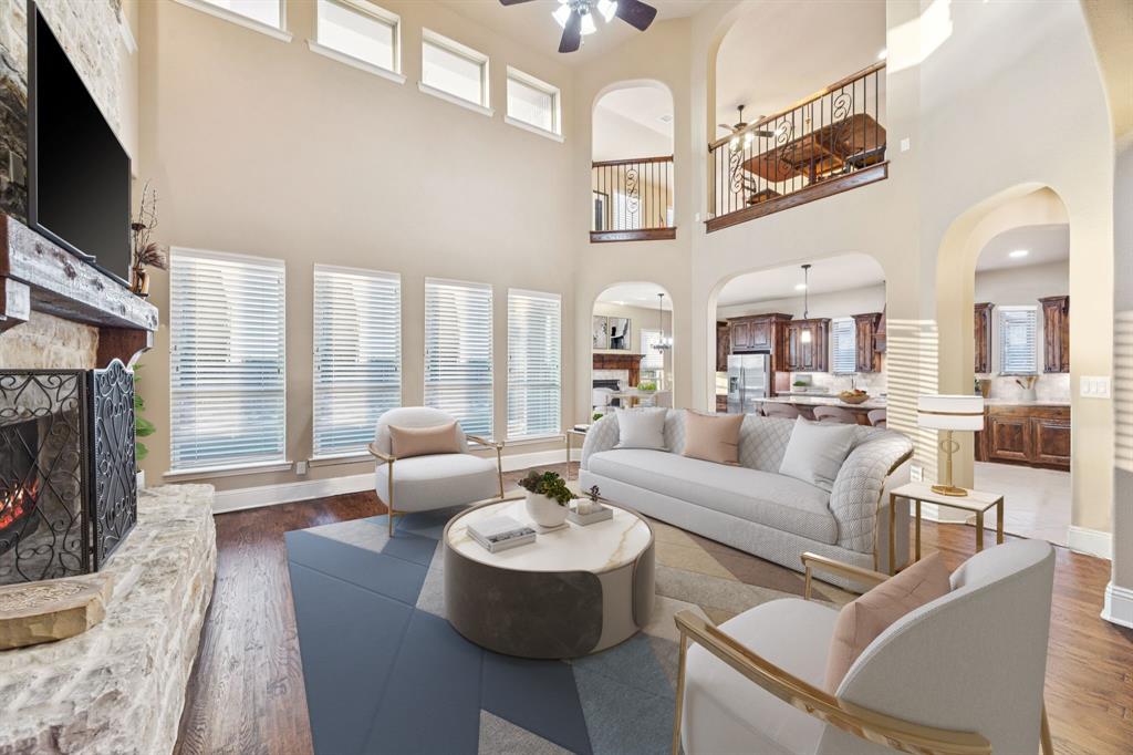 6579 Mountain Sky Road Frisco, TX 75036 - Photo 11 of 40 a living room with furniture a fireplace and a flat screen tv