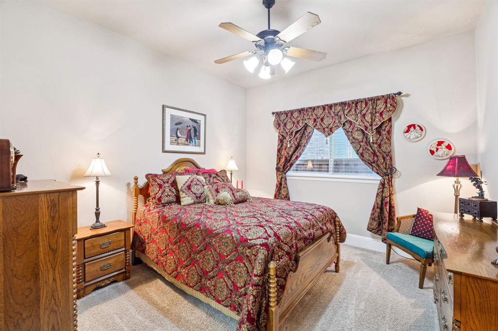 6579 Mountain Sky Road Frisco, TX 75036 - Photo 18 of 40 a bedroom with a bed and a chandelier