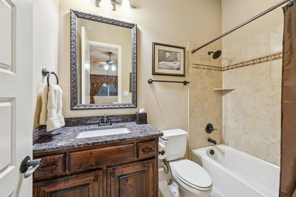6579 Mountain Sky Road Frisco, TX 75036 - Photo 19 of 40 a bathroom with a granite countertop sink toilet and shower