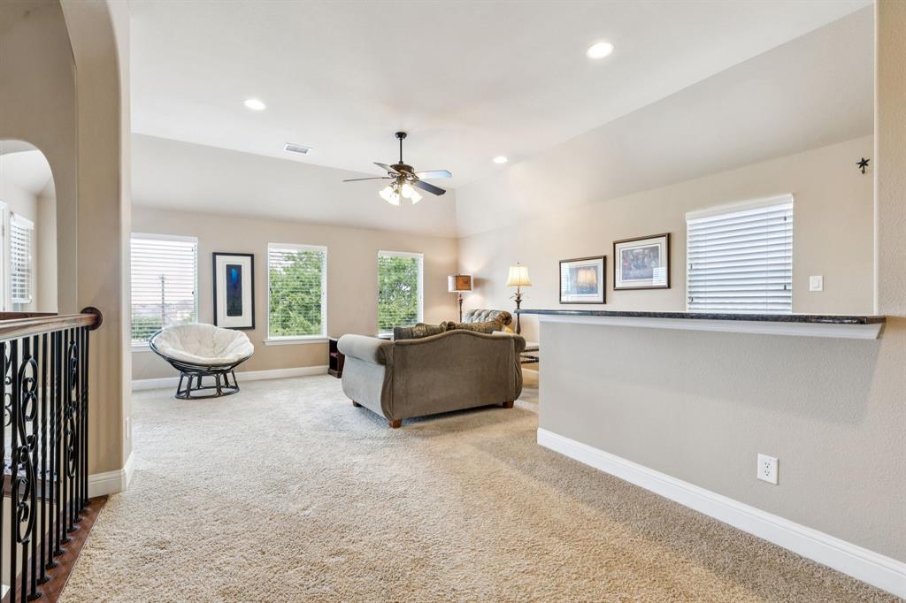 6579 Mountain Sky Road Frisco, TX 75036 - Photo 20 of 40 a living room with furniture and a dining table with wooden floor