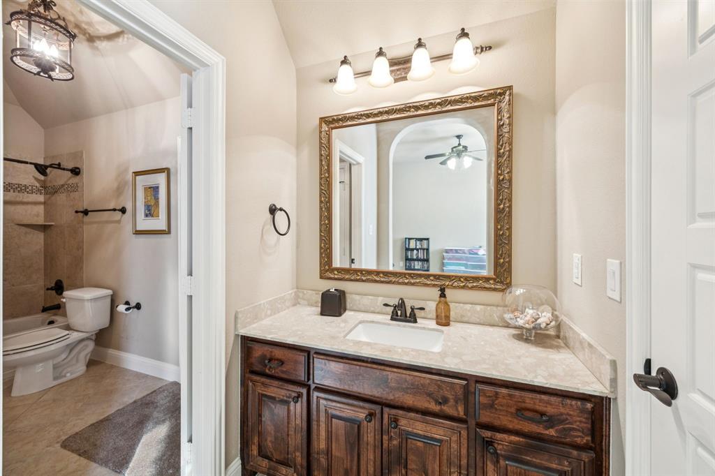 6579 Mountain Sky Road Frisco, TX 75036 - Photo 27 of 40 a bathroom with a granite countertop sink a toilet and a mirror