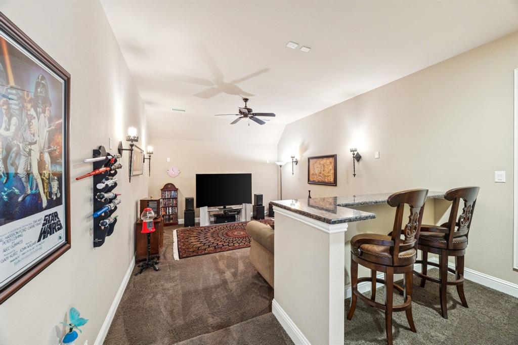 6579 Mountain Sky Road Frisco, TX 75036 - Photo 29 of 40 a view of a livingroom with furniture and a flat screen tv
