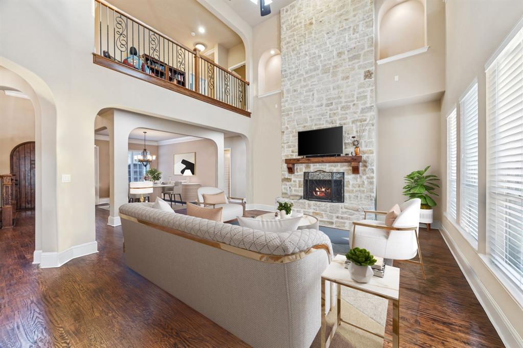 6579 Mountain Sky Road Frisco, TX 75036 - Photo 9 of 40 a living room with fireplace furniture and a flat screen tv