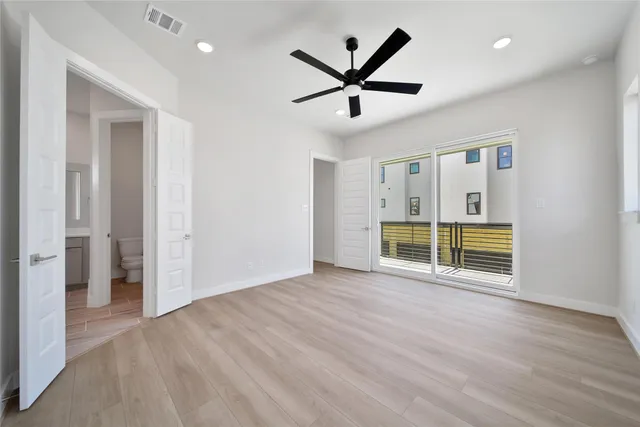 a view of a livingroom with a ceiling fan and wooden floor